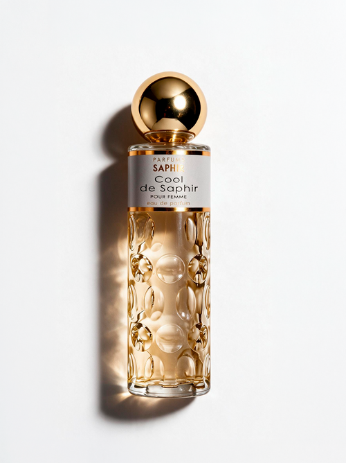 Cool de Saphir eau de parfum for women, gold bottle on white background