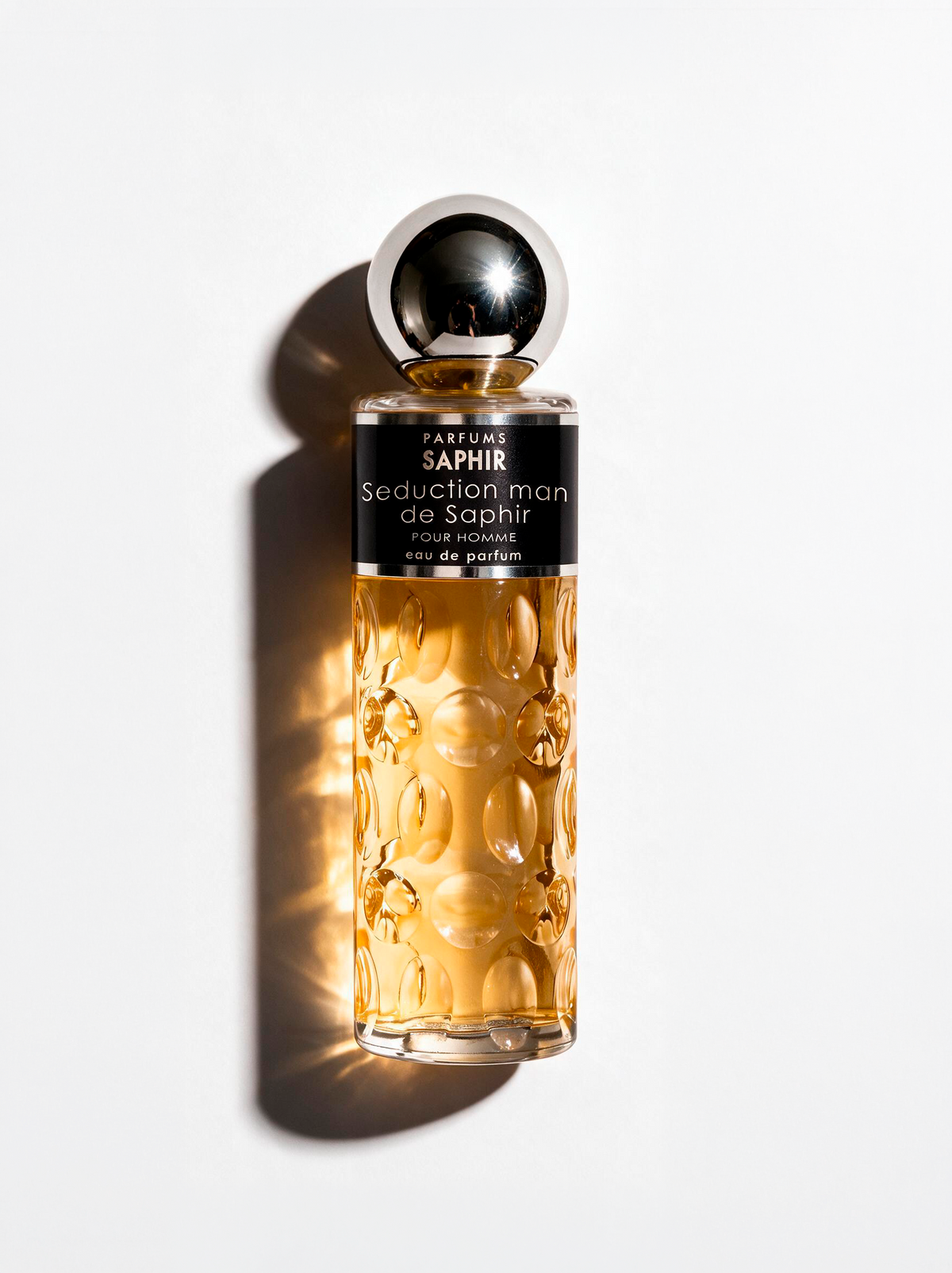 Seduction Man de Saphir eau de parfum for men, amber bottle on white background